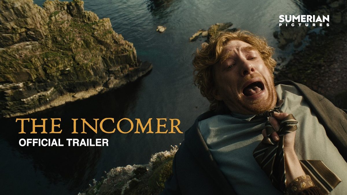 Domhnall Gleeson held over a sea cliff by his tie in the official trailer artwork for The Incomer (2026)